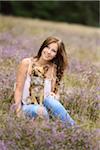 Close-up of a young woman with her chihuahua dog in a Erica meadow in summer, Upper Palatinate, Bavaria, Germany