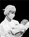 1950s NURSE SURGICAL MASK HOLDING NEWBORN INFANT BABY BOY