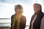 Mother and daughter enjoying view on beach