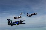 Four young adult male skydivers free falling, Siofok, Somogy, Hungary
