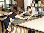Women hand-printing textile in workshop