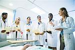 Doctor teaching residents in hospital room