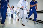 Doctors and nurses rushing in hospital hallway