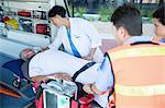 Doctor examining patient on ambulance stretcher