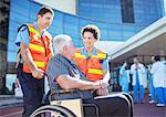 Paramedics talking to patient outside hospital