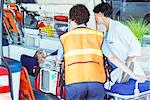 Paramedics wheeling patient out of ambulance