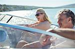 Couple driving boat in water