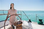 Woman steering boat on water