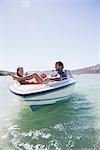 Couple sitting together in boat on water