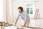 Man overlooking construction table in living space