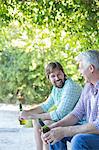 Father and son drinking outdoors