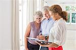 Older couple and woman signing documents