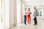 Older couple talking with woman in living space