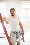 Man standing on ladder in living space