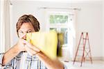 Man holding wood close to face