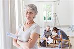 Older woman holding construction plans