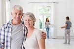 Older couple smiling together in living space