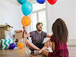 Father and daughter playing with balloons