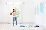 Woman painting walls in living space