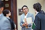 Lawyers talking outside courtroom