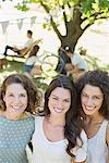 Three women hugging outdoors