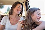 Sisters riding in car backseat together