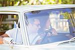 Couple enjoying car ride on sunny day