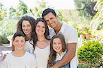 Family hugging outdoors