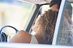 Couple enjoying car ride on sunny day