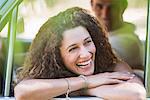 Woman relaxing on car door during car ride