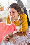 Daughter putting flour on mother's nose