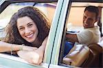 Woman relaxing on car door during car ride