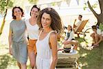 Woman smiling outdoors with family near