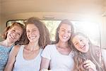 Four women sitting in backseat of car