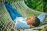 Teenage boy lying in hammock