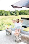 Man relaxing in garden, Stockholm, Sweden