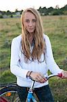 Portrait of teenage girl with bicycle, Sweden