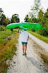 Boy walking with inflatable crocodile