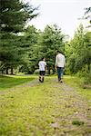 Two brothers walking on a country path.