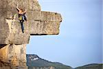 Young female rock climber on a cliff