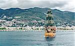 Beautiful landscape with sea, mountain range and ship over Alanya city background. Turkey