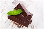 Mint chocolate on white wooden background. Luxurious culinary chocolate background.