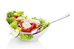 Vegetable salad. Colorful fresh vegetable in bowl with fork isolated on white background with reflection. Healthy eating.