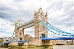 London Tower Bridge is a combined bascule and suspension bridge in London which crosses the River Thames. It is close to the Tower of London, from which it takes its name, and has become an iconic symbol of London.    Built during 1886 – 1894, the bridge consists of two towers tied together at the upper level by means of two horizontal walkways, designed to withstand the horizontal forces exerted