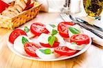 Caprese salad with mozarella cheese, tomatoes, basil