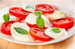 Caprese salad with mozarella cheese, tomatoes, basil