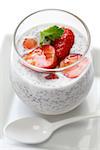 coconut chia seed pudding with strawberries isolated on white background