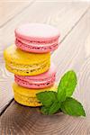 Colorful macaron cookies on wooden table background
