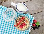 Healthy breakfast with muesli and milk. View from above on wooden table
