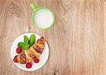 Milk and fresh croissant on wooden table with copy space